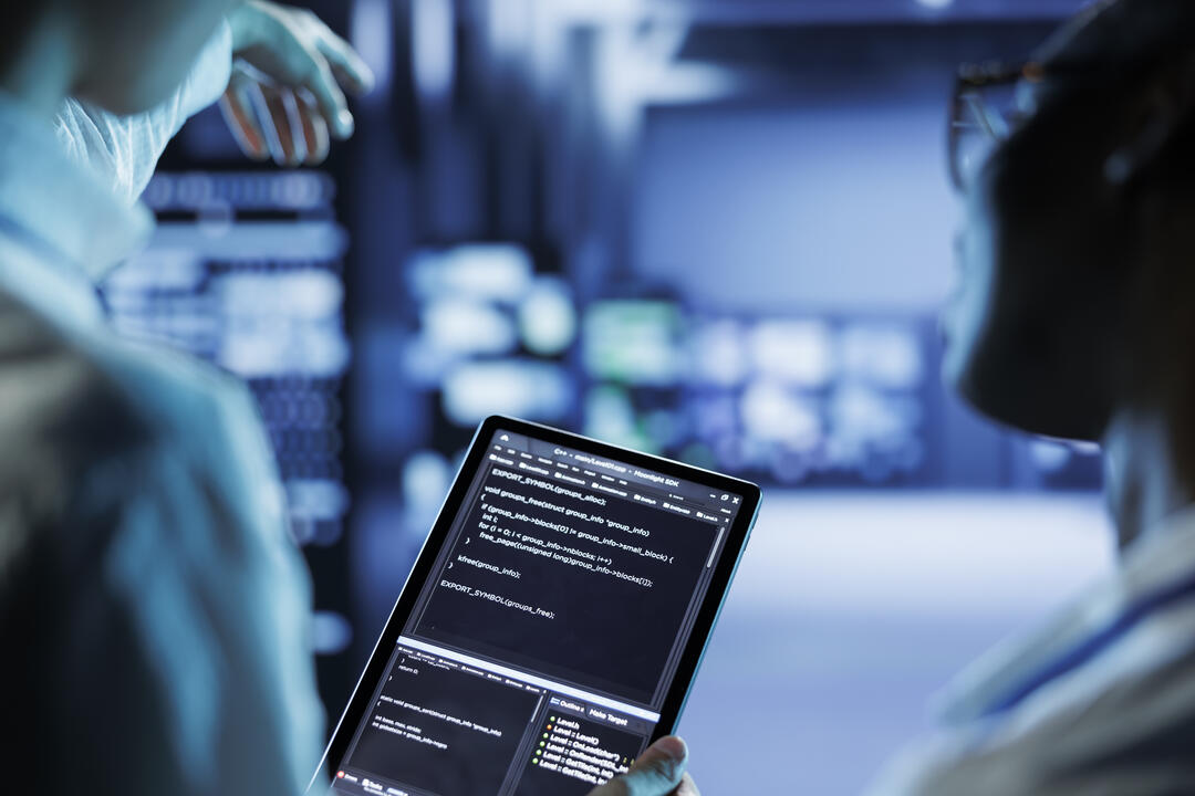 Engineers code on tablet in data center